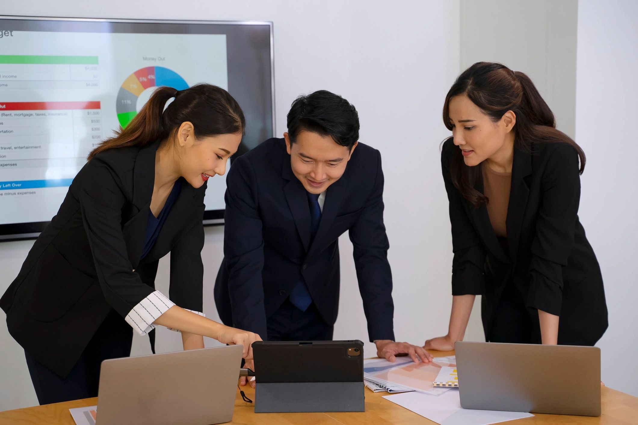 Coworkers meeting in an office and discussing work